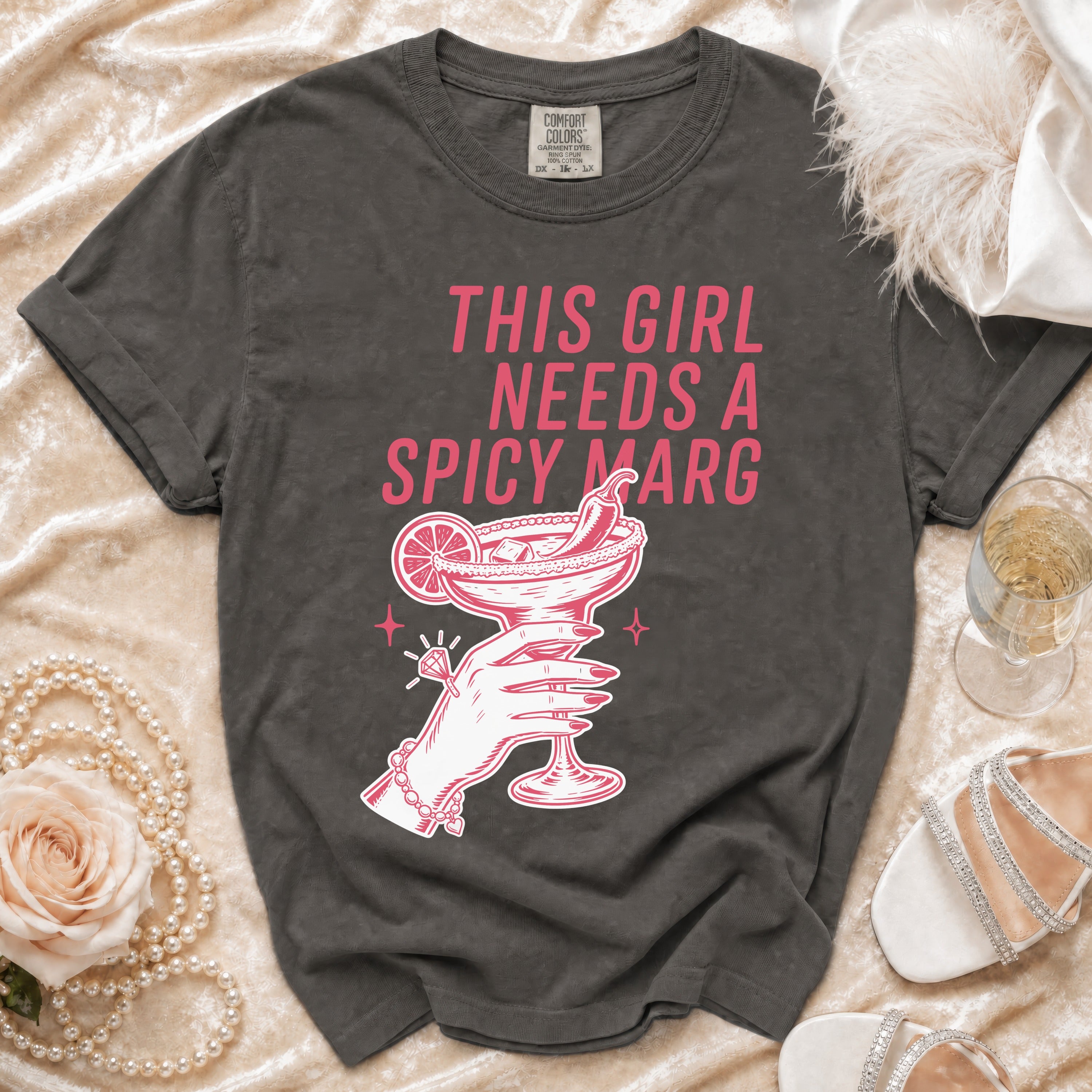 Dark gray t-shirt with "This girl needs a spicy marg" text and margarita illustration.