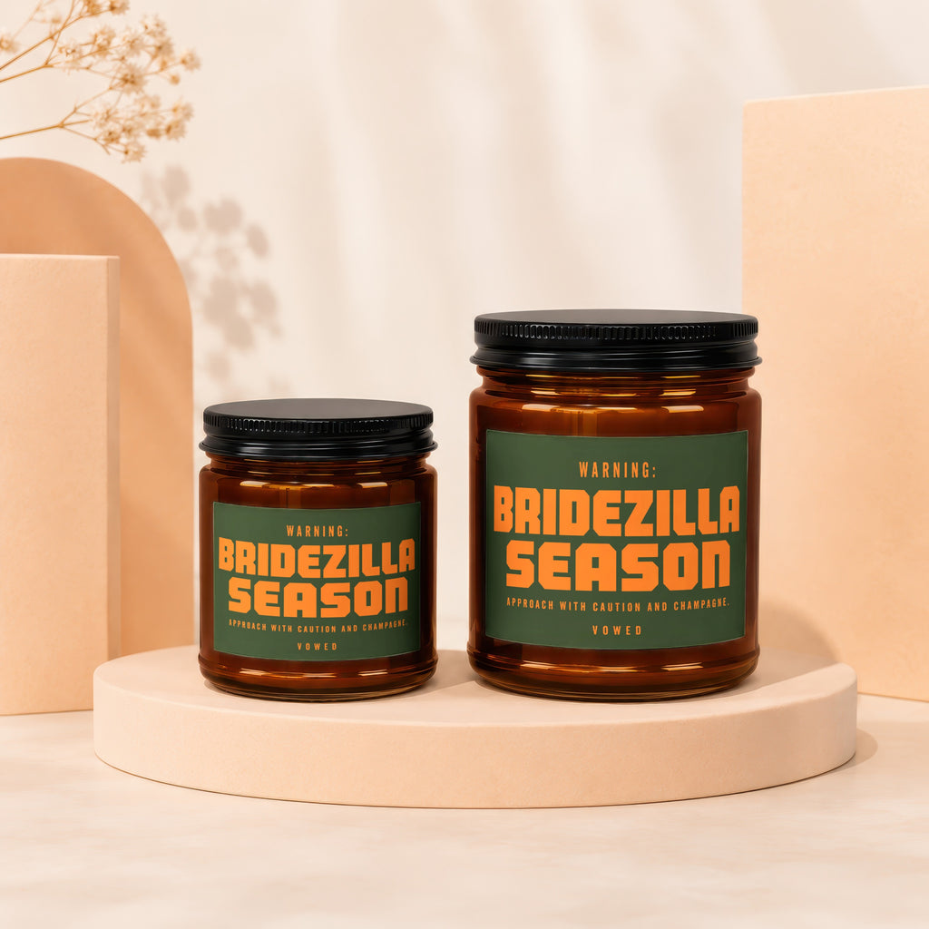 Two amber glass candles with "Bridezilla Season" warning labels and black lids.