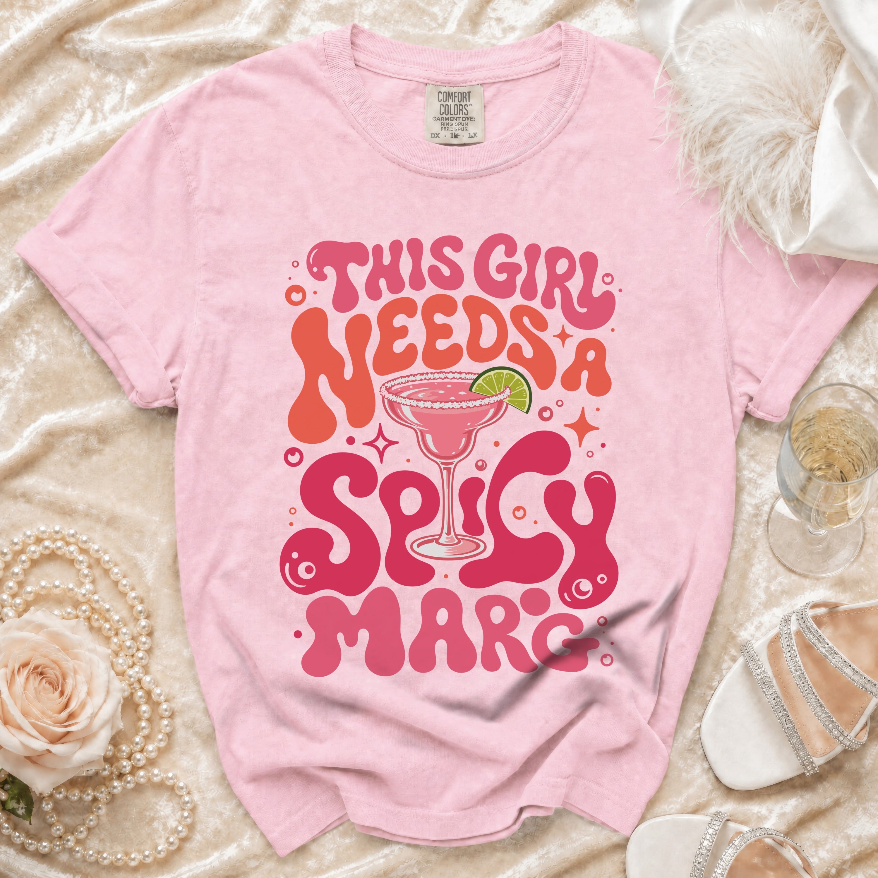 Pink Comfort Colors t-shirt with "This Girl Needs A Spicy March" graphic.