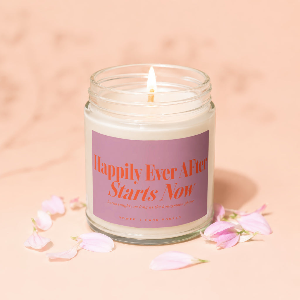Jar candle with pink label reading "Happily Ever After Starts Now".