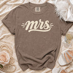 Brown Comfort Colors t-shirt with "mrs" in cream lettering.