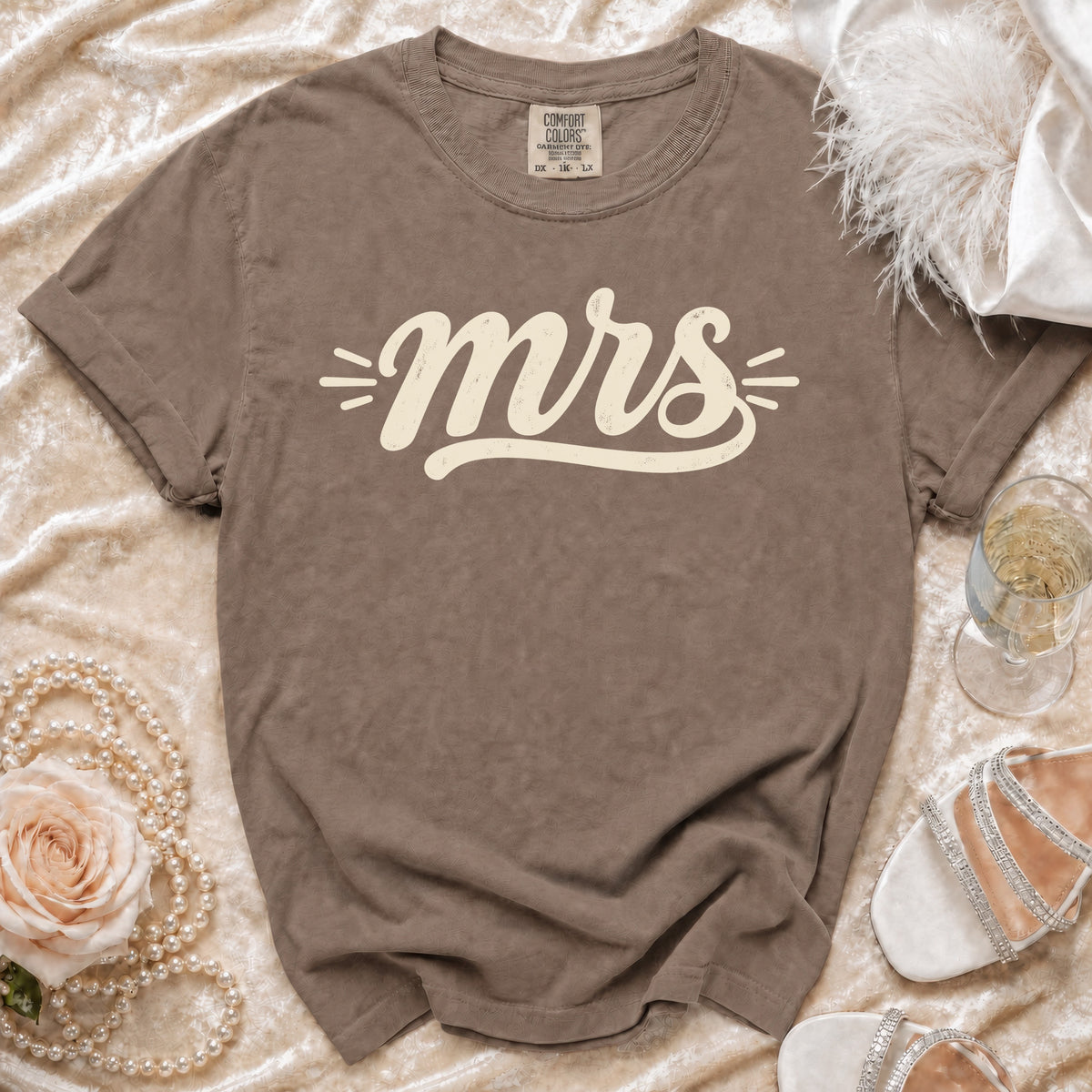 Brown Comfort Colors t-shirt with "mrs" in cream lettering.