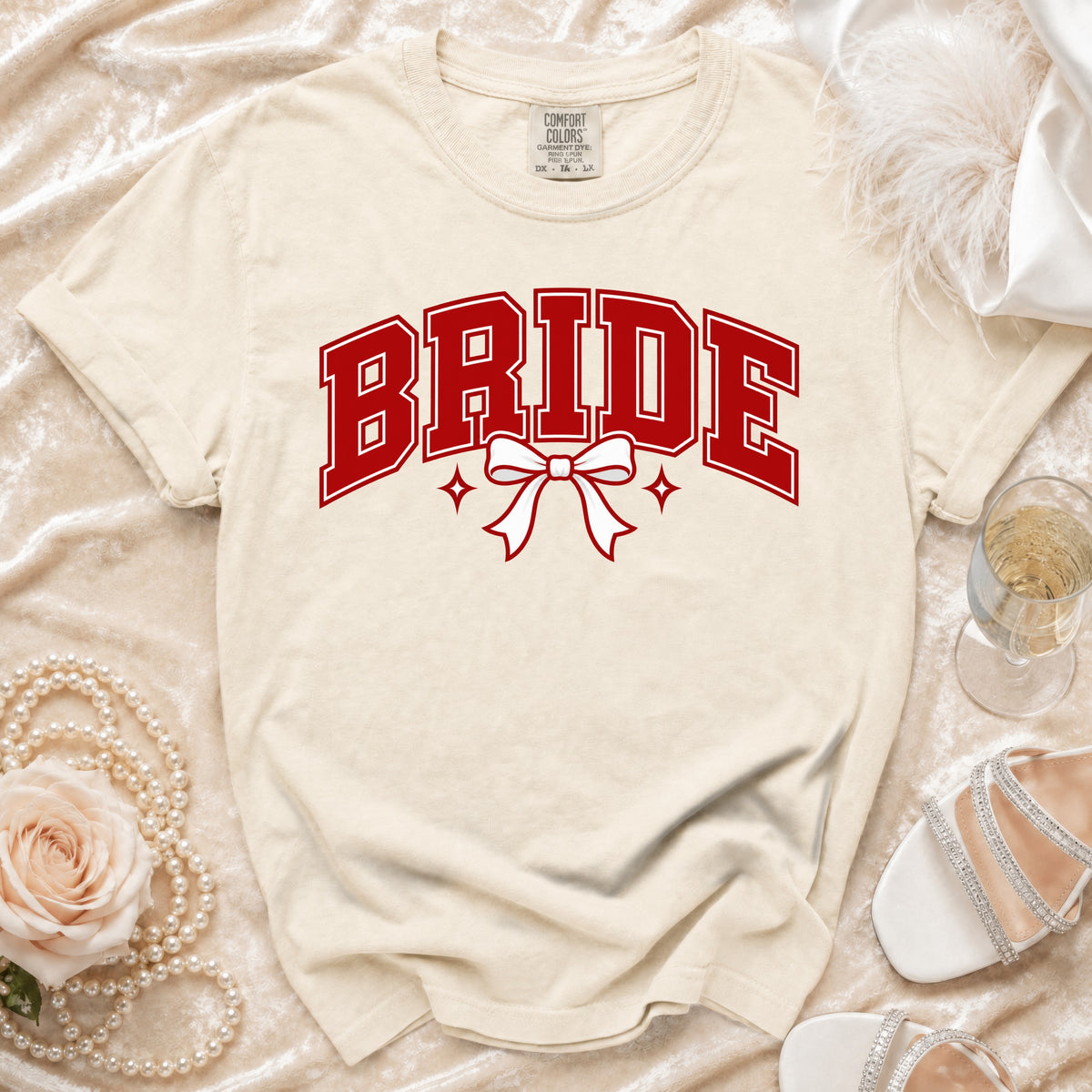 Cream t-shirt with red "BRIDE" text and white bow graphic.