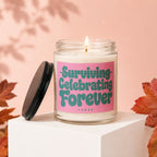 Candle with "Surviving Celebrating Forever" text on label, lid off.