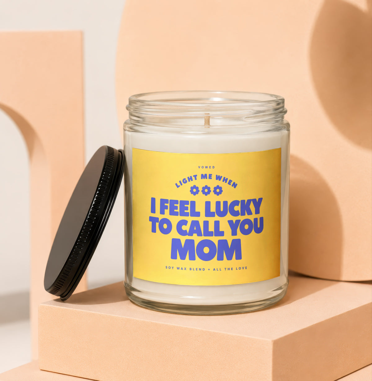 Glass candle with yellow label reading "I FEEL LUCKY TO CALL YOU MOM"