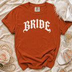 Orange t-shirt with white "BRIDE" text, shown with accessories.