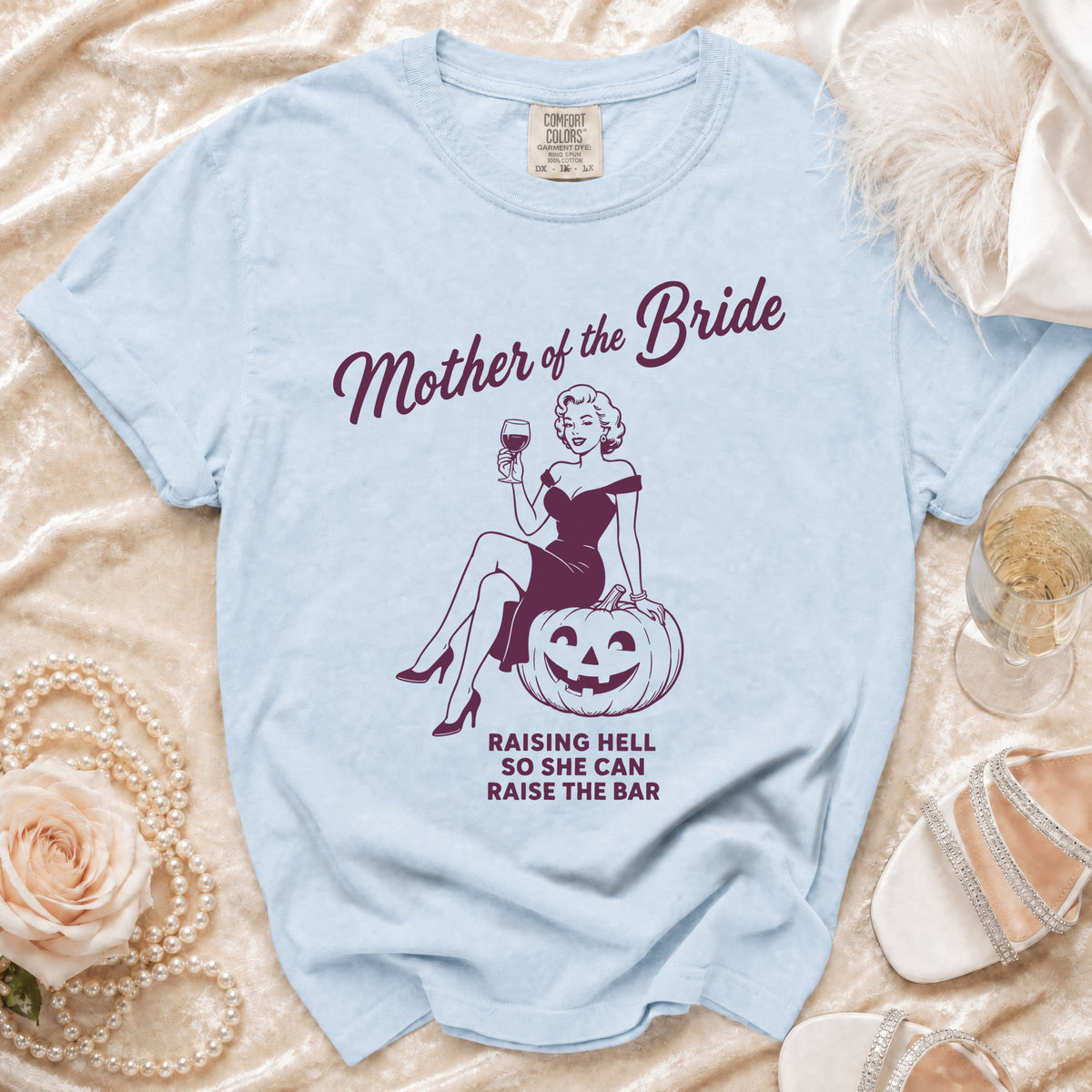 Light blue t-shirt with "Mother of the Bride" text and graphic.