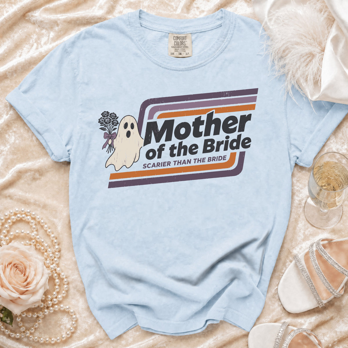 Light blue t-shirt with a ghost holding flowers and text "Mother of the Bride Scarier Than the Bride".