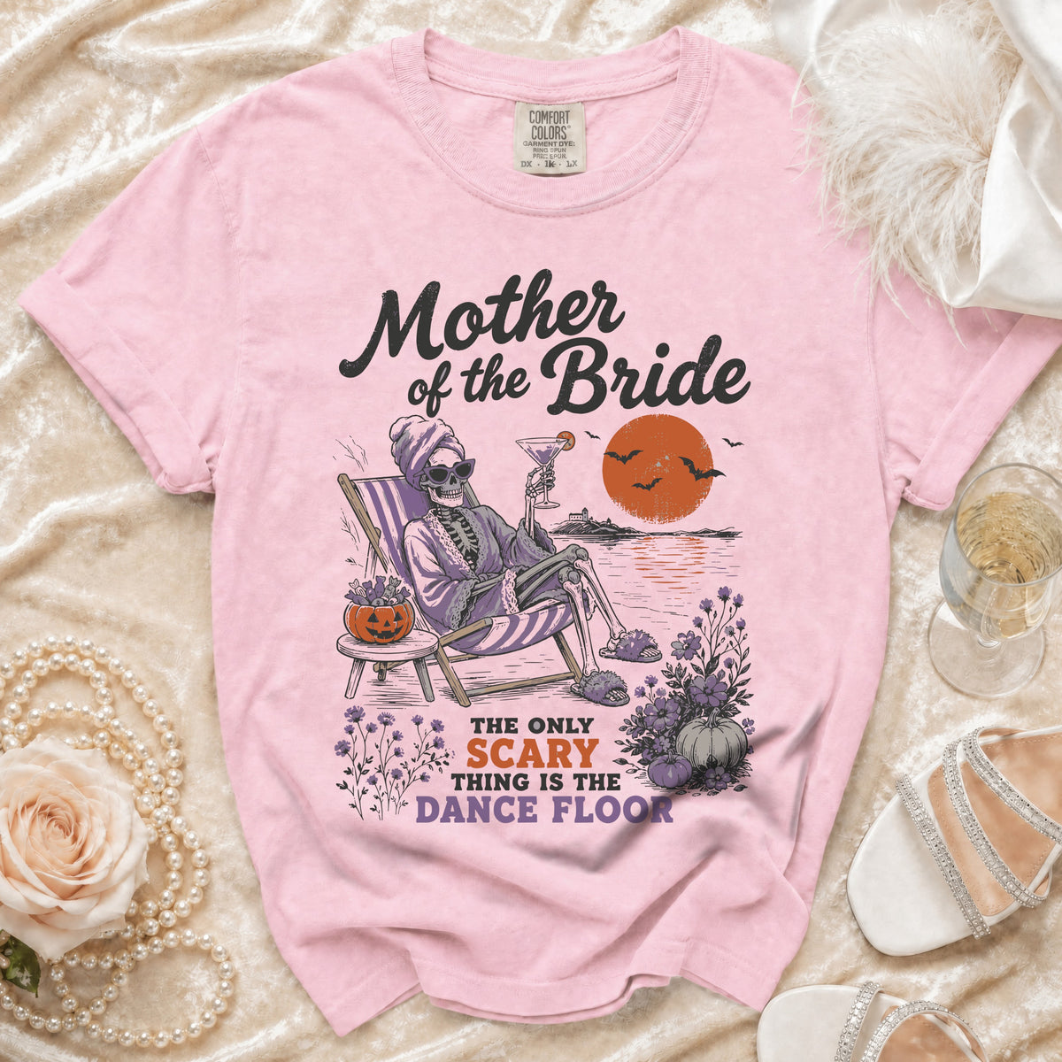 Pink t-shirt with skeleton graphic and "Mother of the Bride" text.