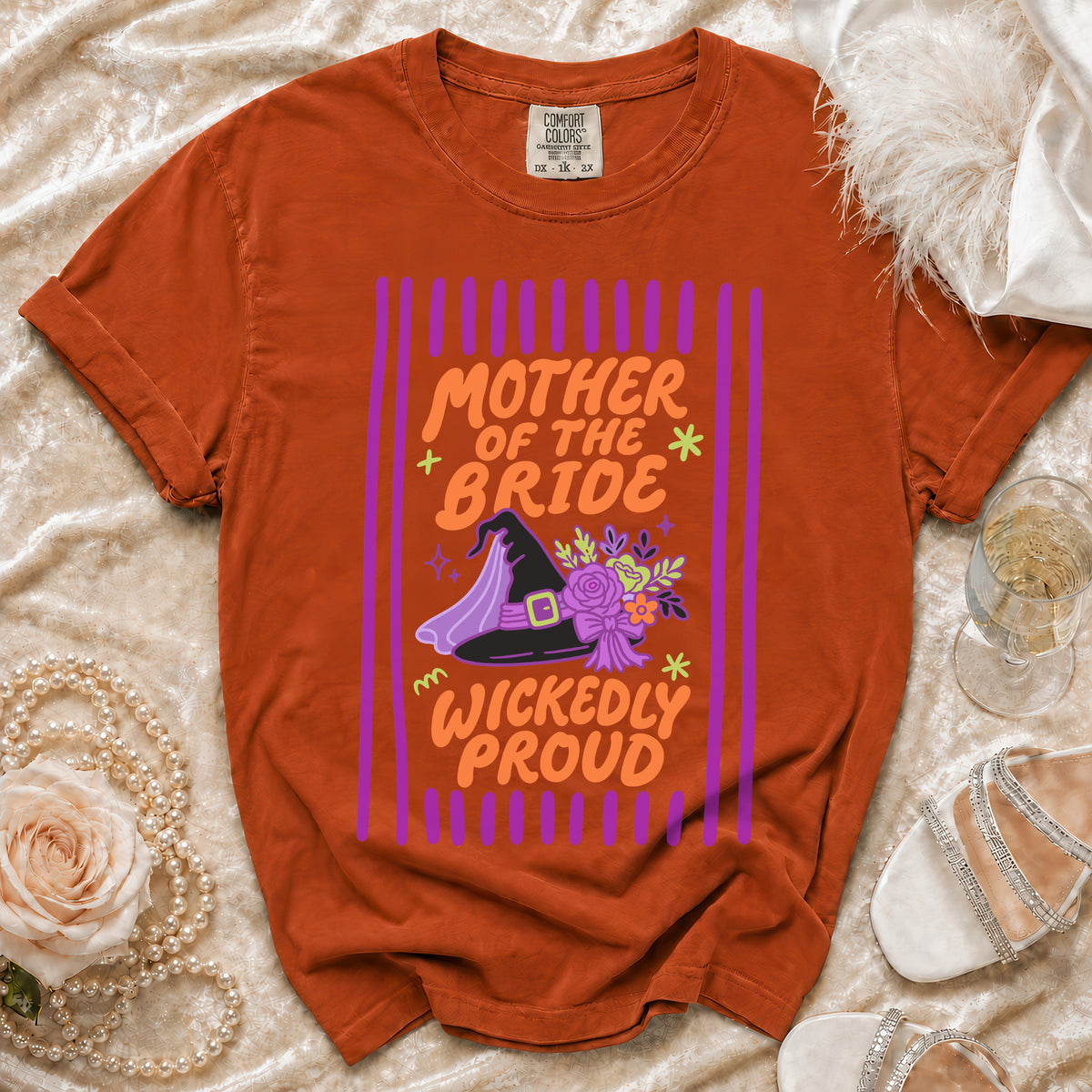 Orange t-shirt with "Mother of the Bride Wickedly Proud" text and witch hat graphic.