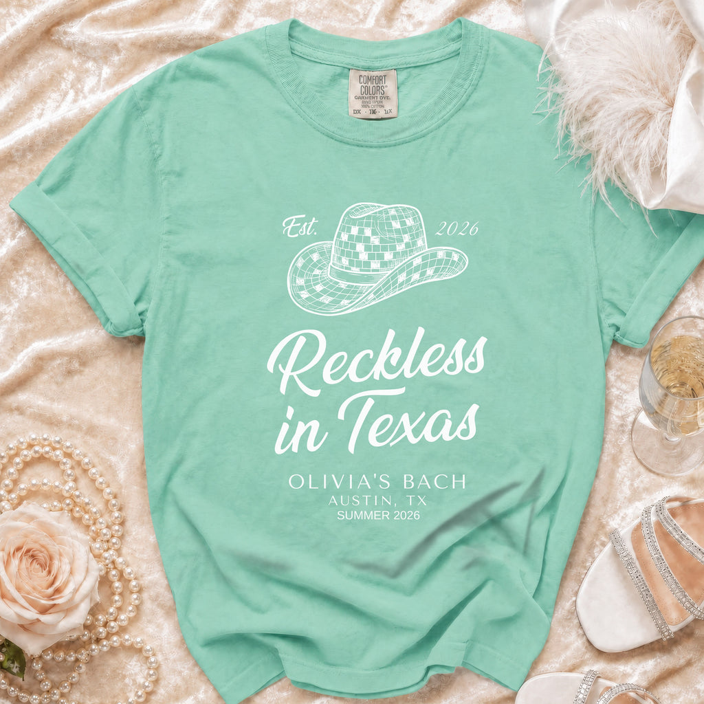 T-shirt with "Reckless in Texas" and cowboy hat graphic.