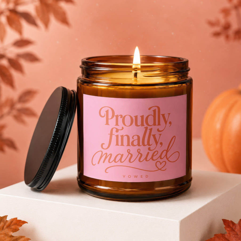 Amber candle with pink label reading "Proudly, finally, married VOWED."