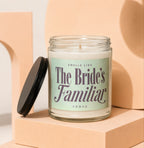 Glass candle with a black lid, labeled "Smells Like The Bride's Familiar Vowed."