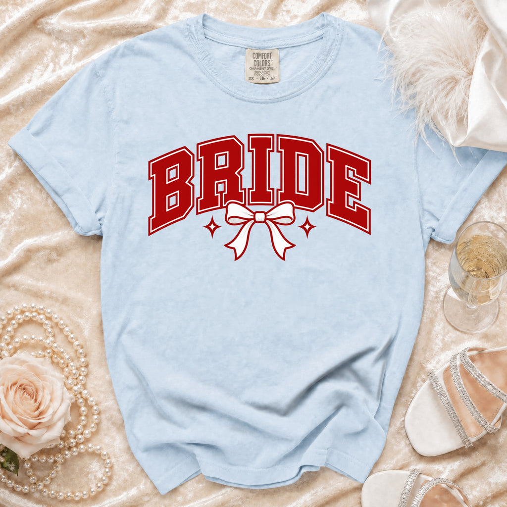 Light blue t-shirt with "BRIDE" in red lettering and a white bow.