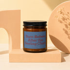 Amber jar candle with blue label reading "Burn Before After the Seating Chart"