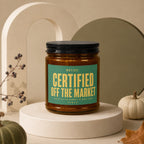 Amber jar candle with green label text "CERTIFIED OFF THE MARKET".