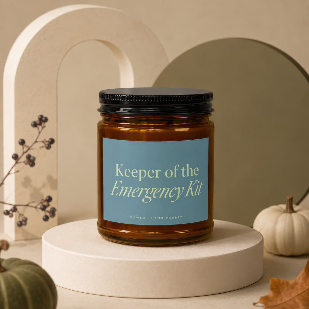 Amber jar candle labeled "Keeper of the Emergency Kit," hand-poured.