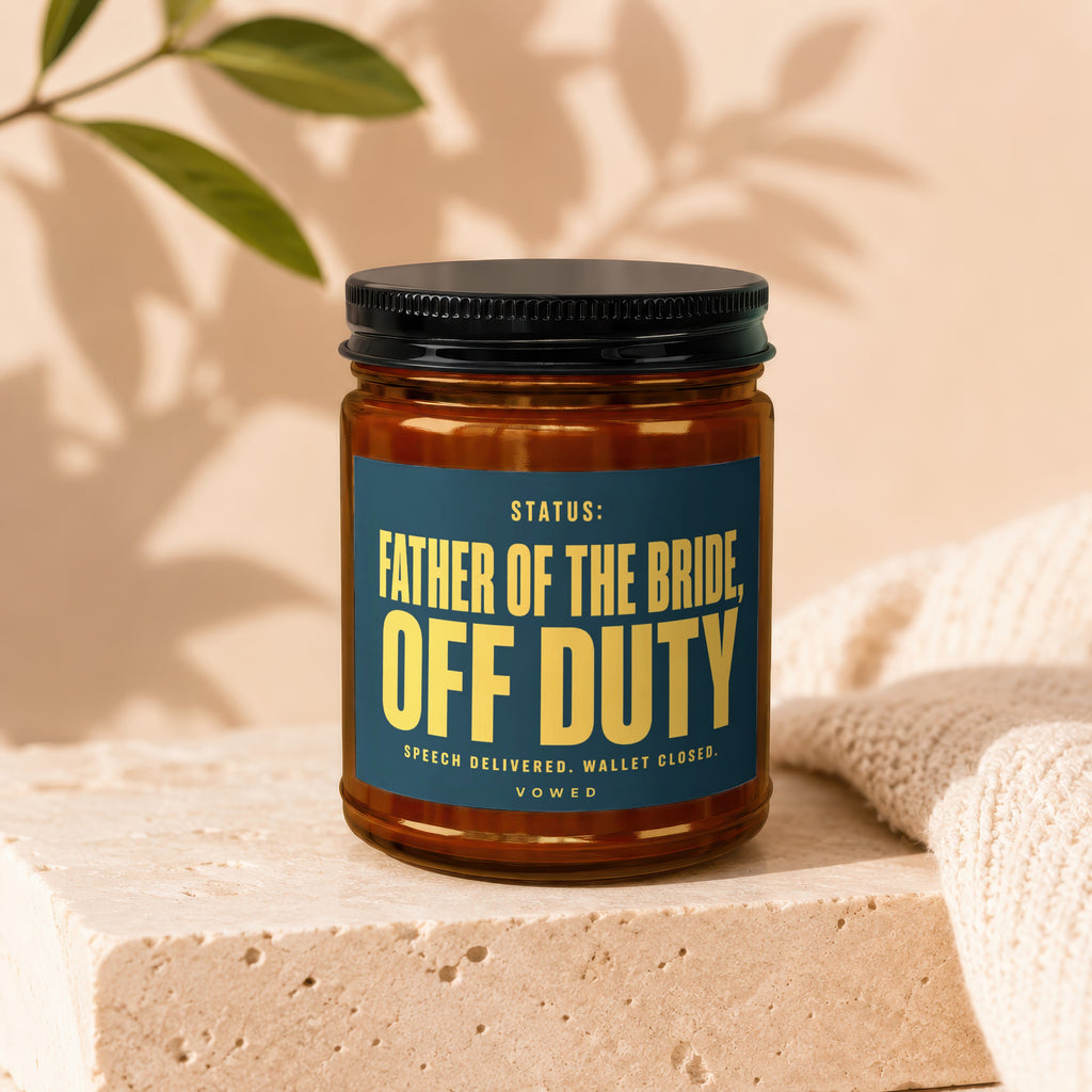 Amber jar candle with dark blue label reading "Father of the Bride Off Duty".