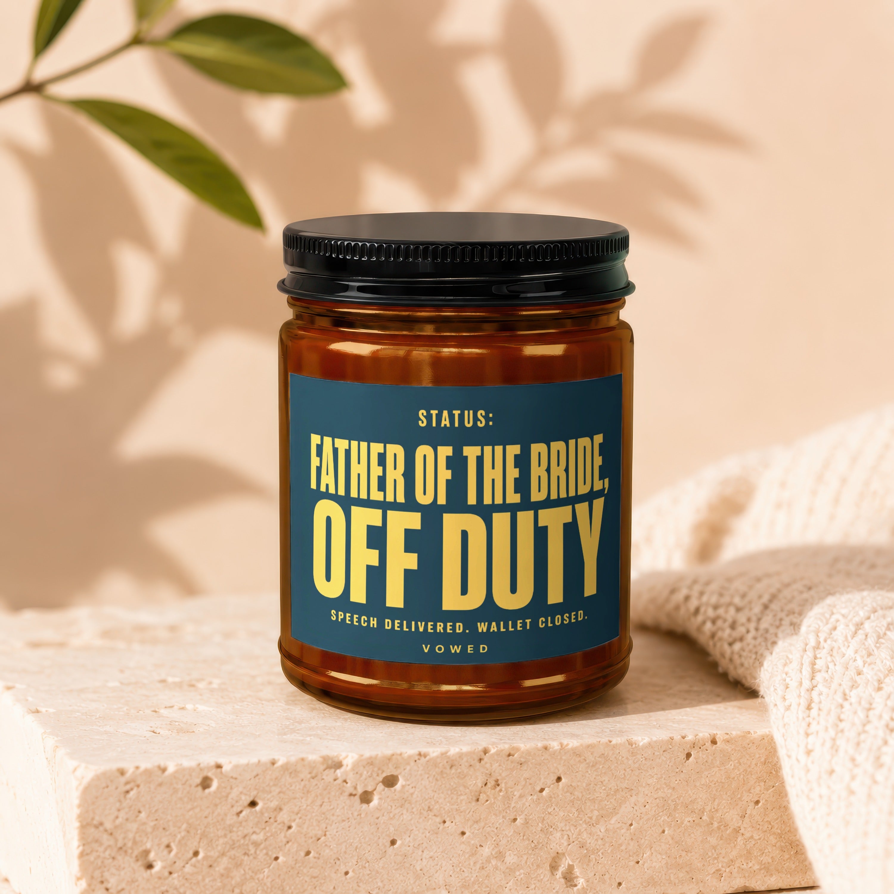 Amber jar candle with dark blue label reading "Father of the Bride Off Duty".