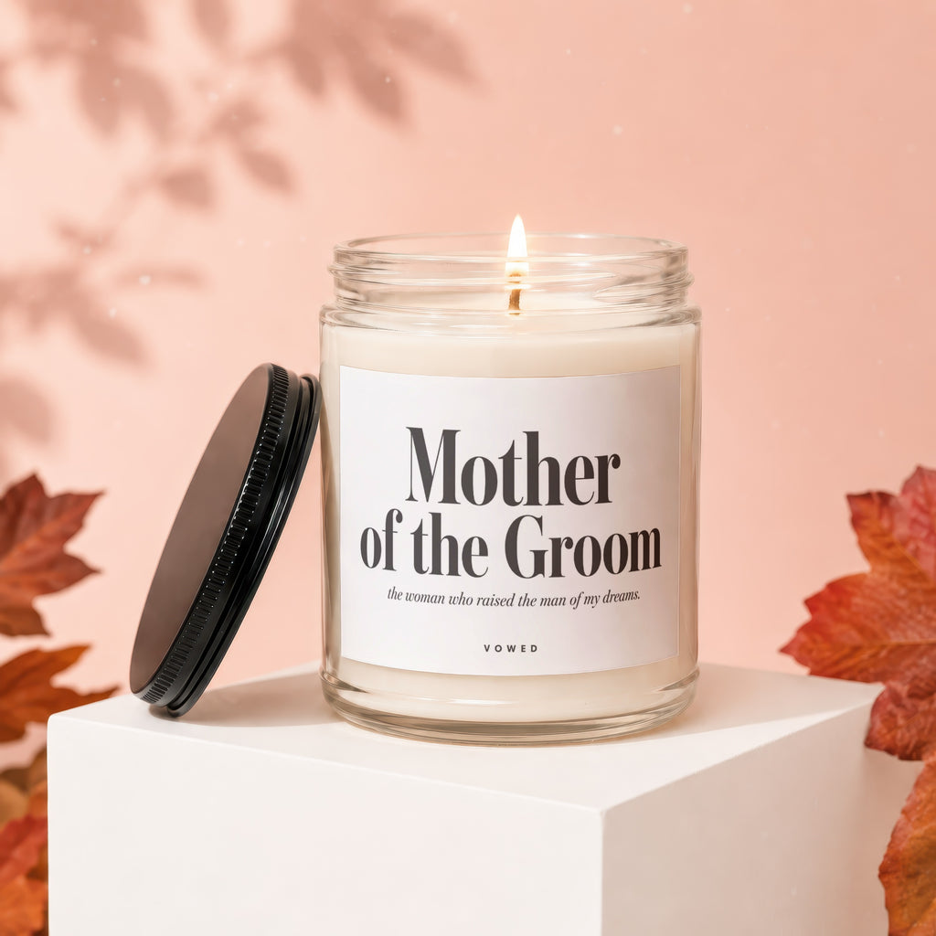 Glass candle labeled "Mother of the Groom" with flickering flame.