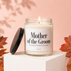 Glass candle labeled "Mother of the Groom" with flickering flame.
