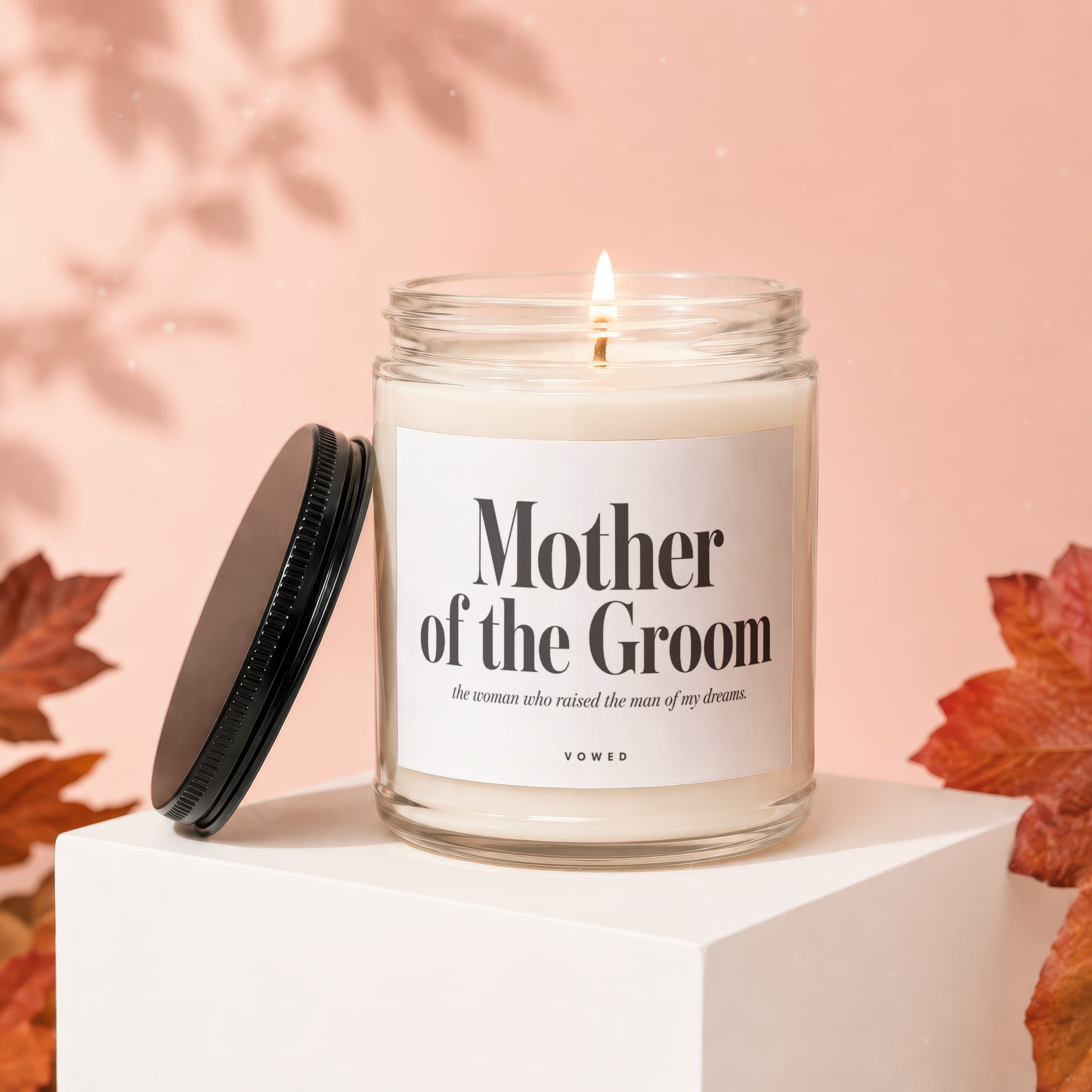 Glass candle labeled "Mother of the Groom" with flickering flame.