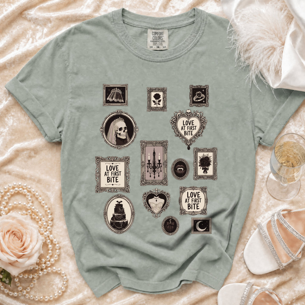 Light green t-shirt with framed gothic illustrations and "Love at First Bite" text.