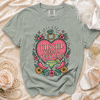 Green t-shirt with "This girl needs a spicy marg" text and margarita graphic.