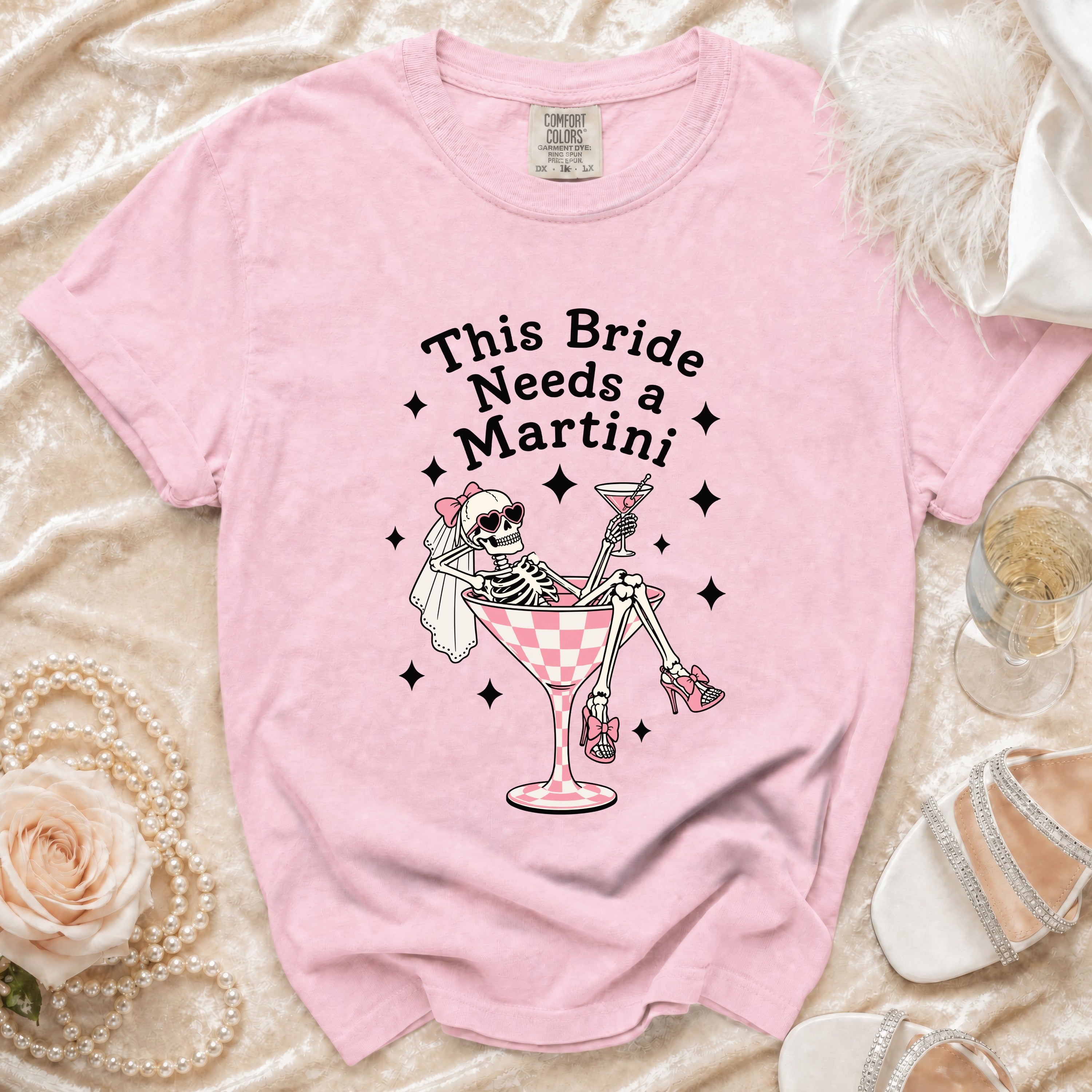 Pink t-shirt with skeleton bride graphic saying "This Bride Needs a Martini".