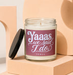 Glass candle with "Yaaas we said I do" text on maroon label.