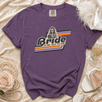 Purple t-shirt with skeleton bride graphic that says "Bride To Be, Not To Die".
