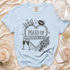 Light blue t-shirt with "MAID OF DISHONOR" text, crown, lips, roses, and champagne glasses.
