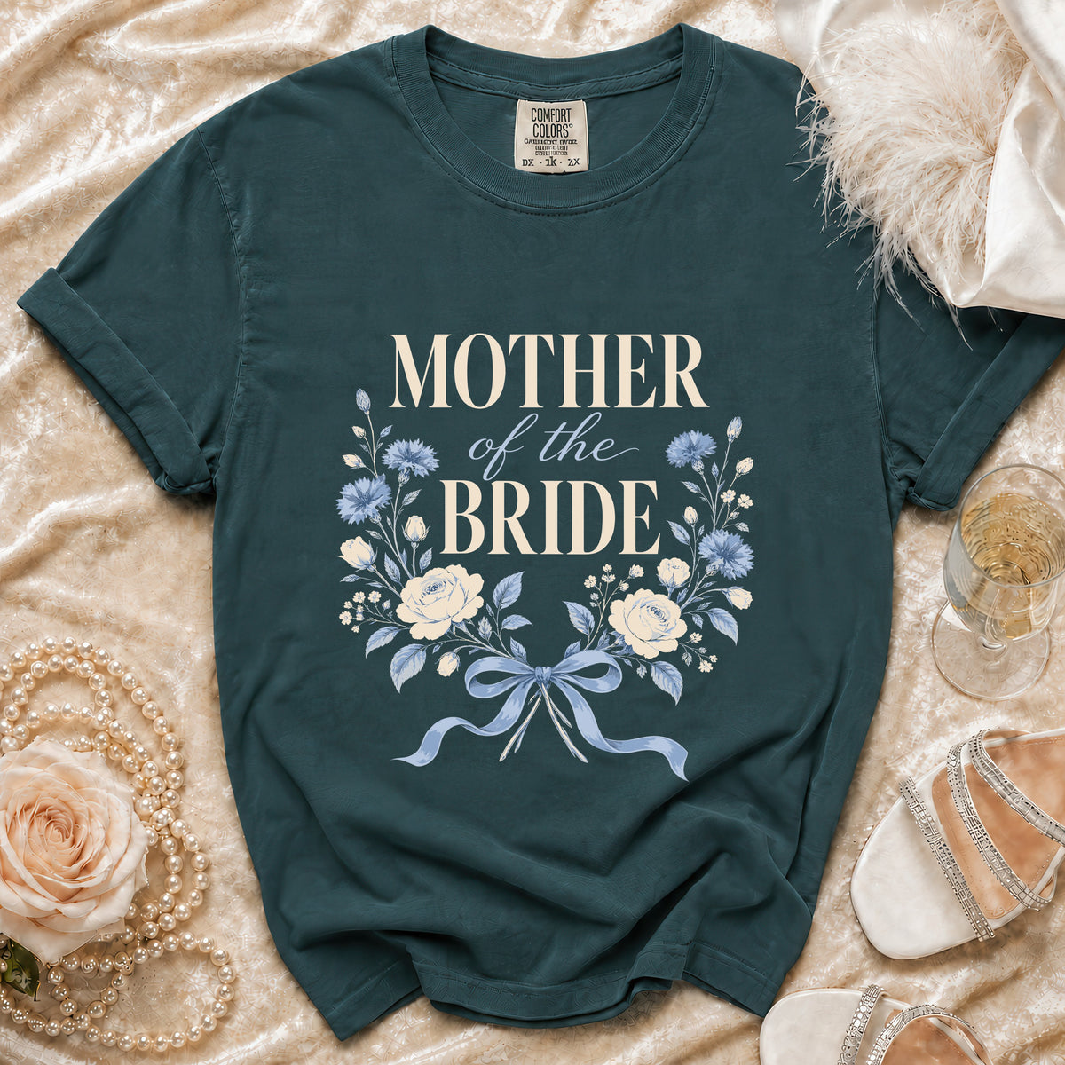Green t-shirt with "MOTHER of the BRIDE" text and floral wreath design.