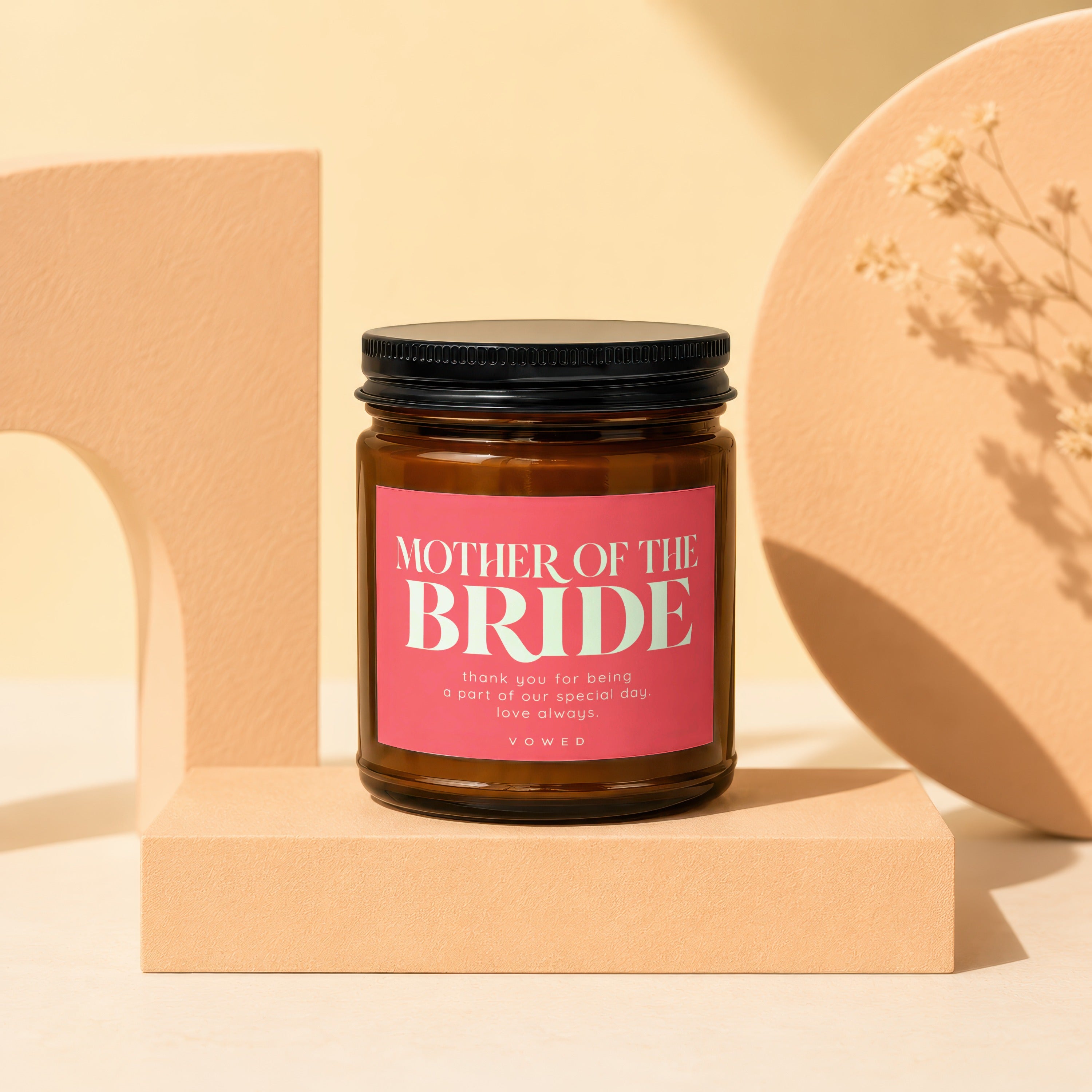 Brown candle with pink label that reads "Mother of the Bride".
