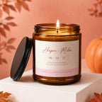 Amber candle with "Harper + Miles" and engagement message on label.