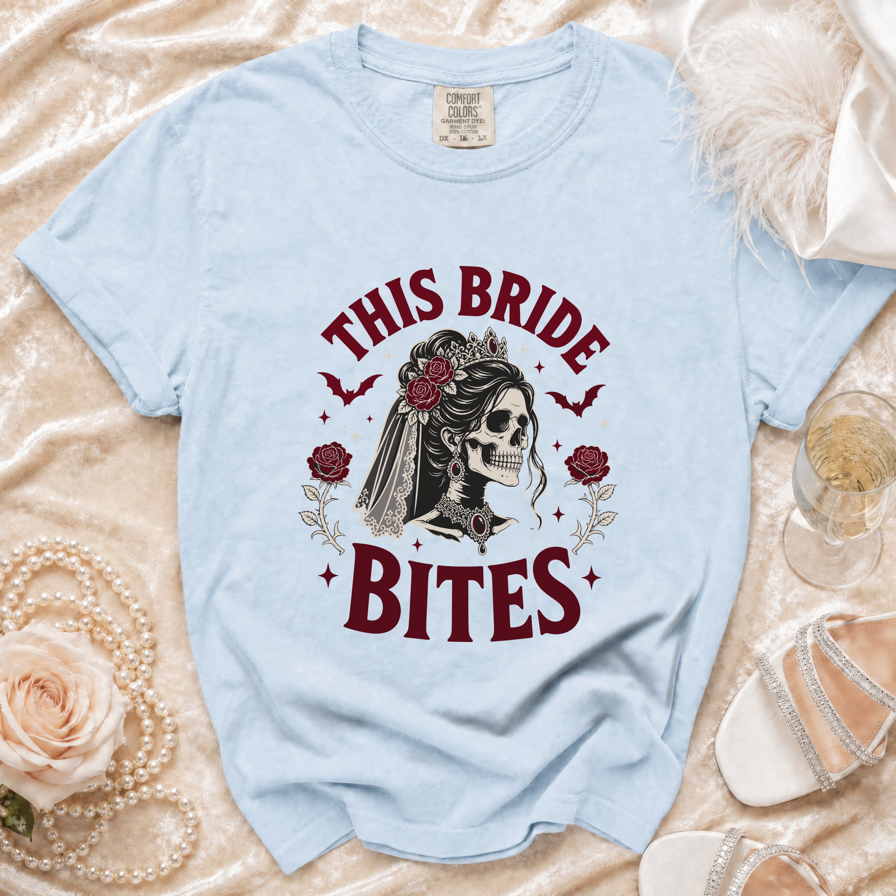 Light blue t-shirt with "This Bride Bites" text and skull bride graphic.