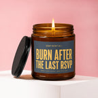 Amber jar candle with lit flame, lid removed, reads "Burn After The Last RSVP".