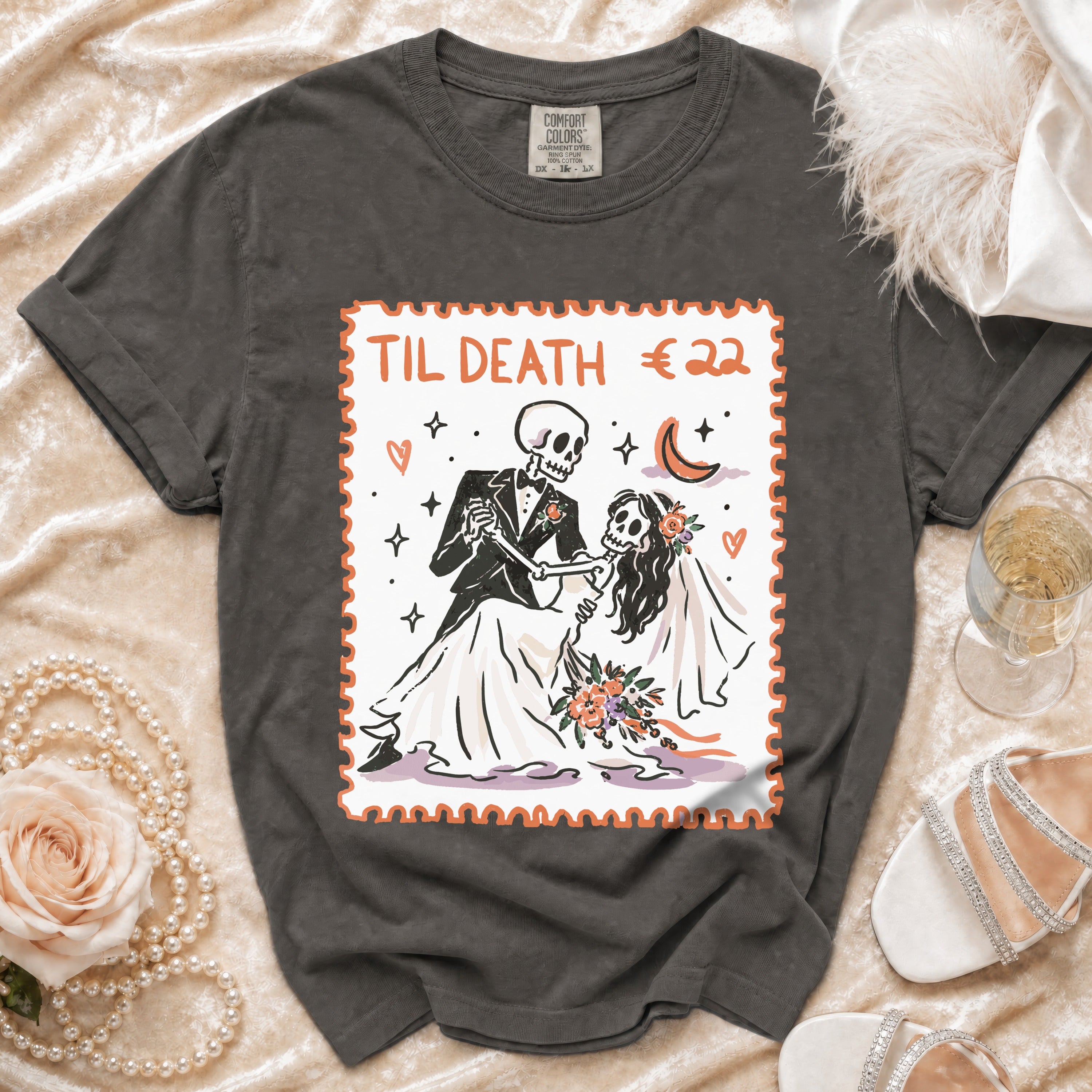 T-shirt with skeletons in wedding attire and "Til Death €22" text.