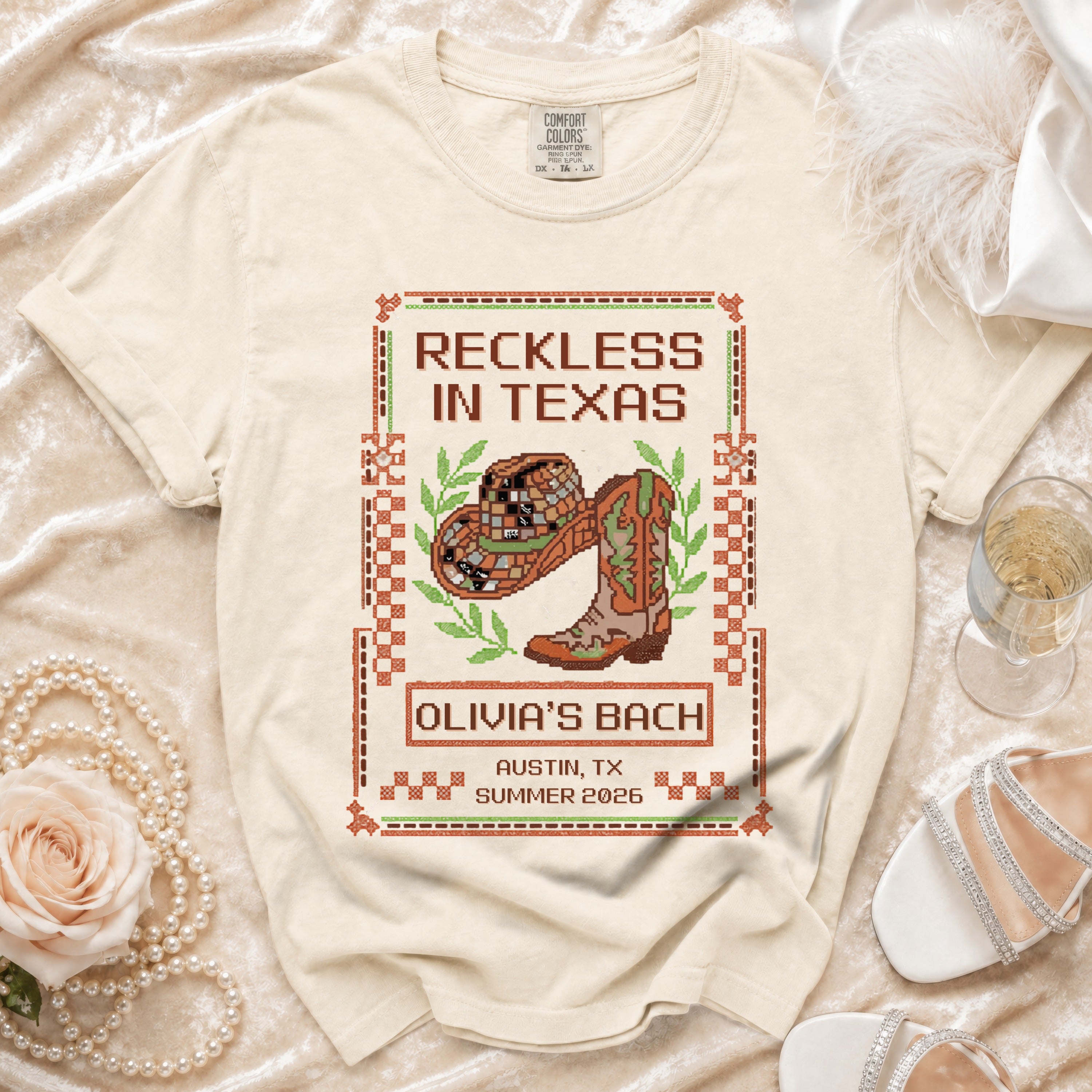 T-shirt with "Reckless in Texas" text, cowboy hat, and boots for Olivia's Bach, Austin, TX.