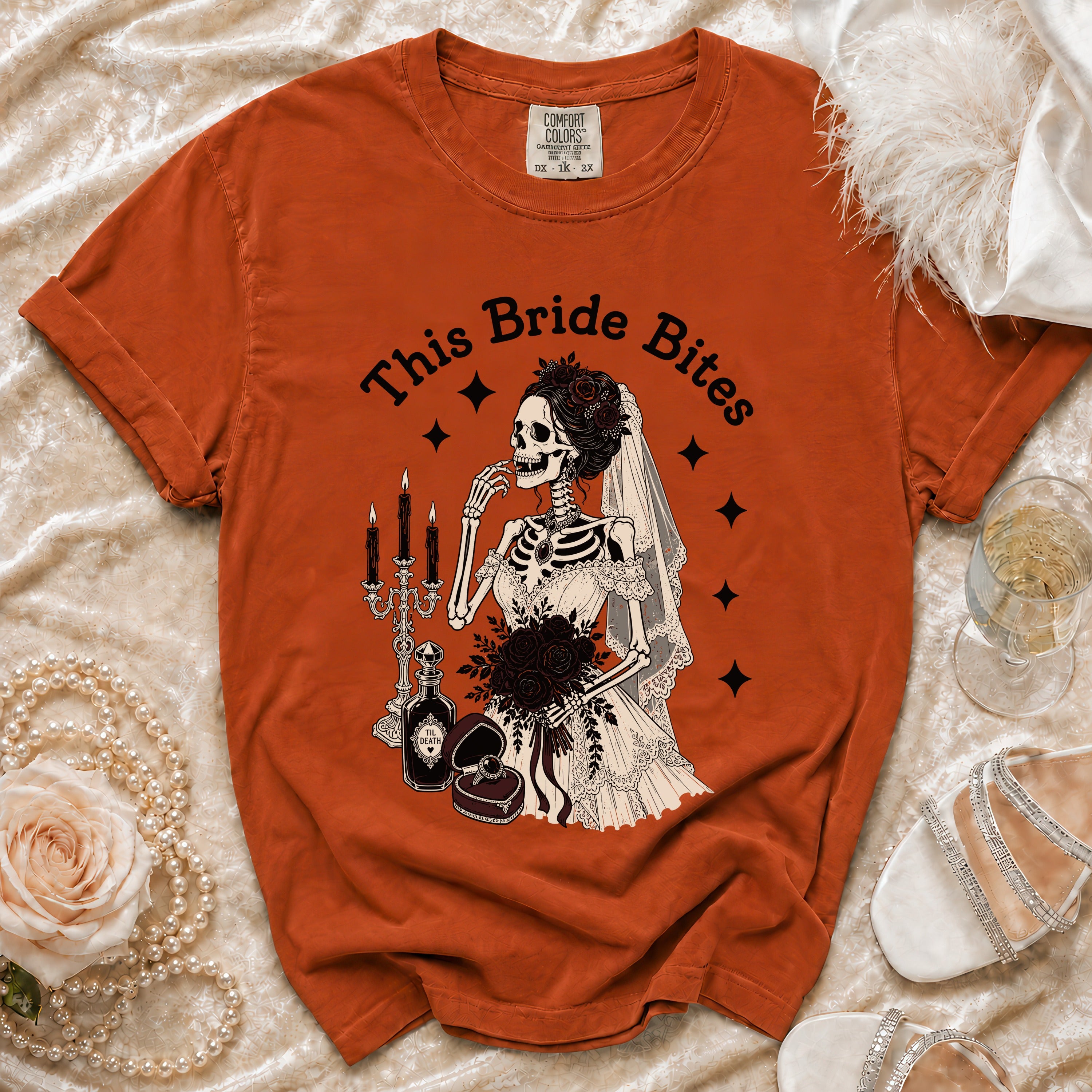 Orange t-shirt with skeleton bride graphic that reads "This Bride Bites".