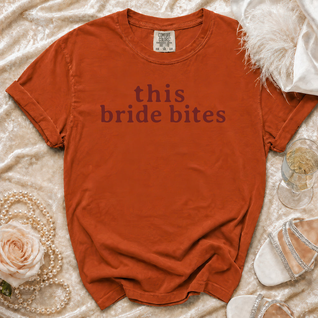 Comfort Colors t-shirt with "this bride bites" text, styled with pearls and heels.