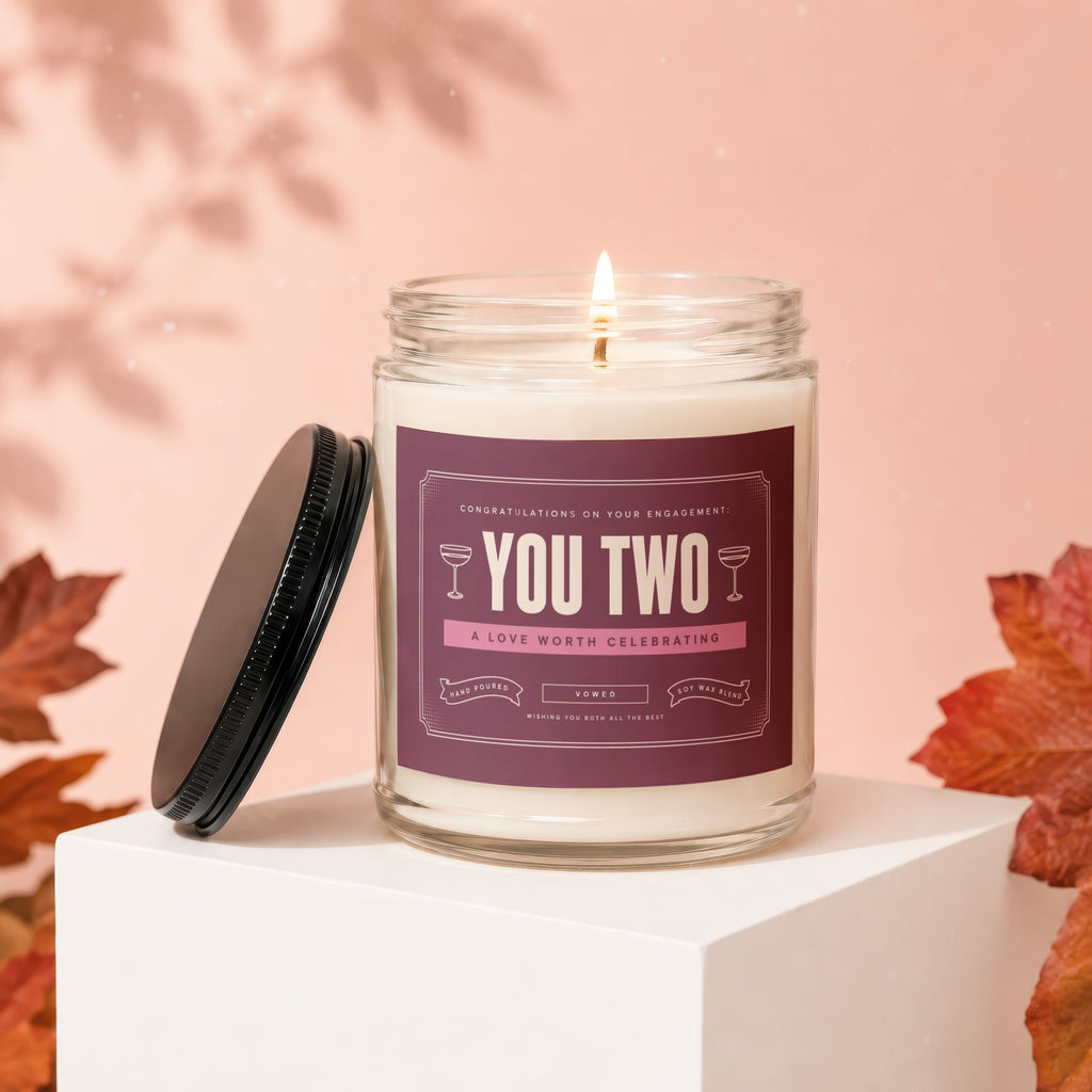 Engagement candle with "You Two" text, "A Love Worth Celebrating" and "Vowed."
