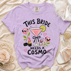 Lavender t-shirt with "This Bride Needs a Cosmo" and martini glass graphic.