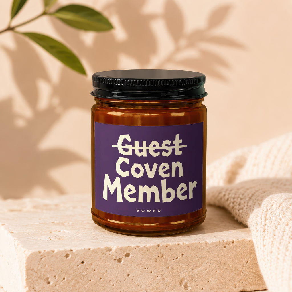 Amber jar candle, purple label with white text reading "Guest Coven Member".