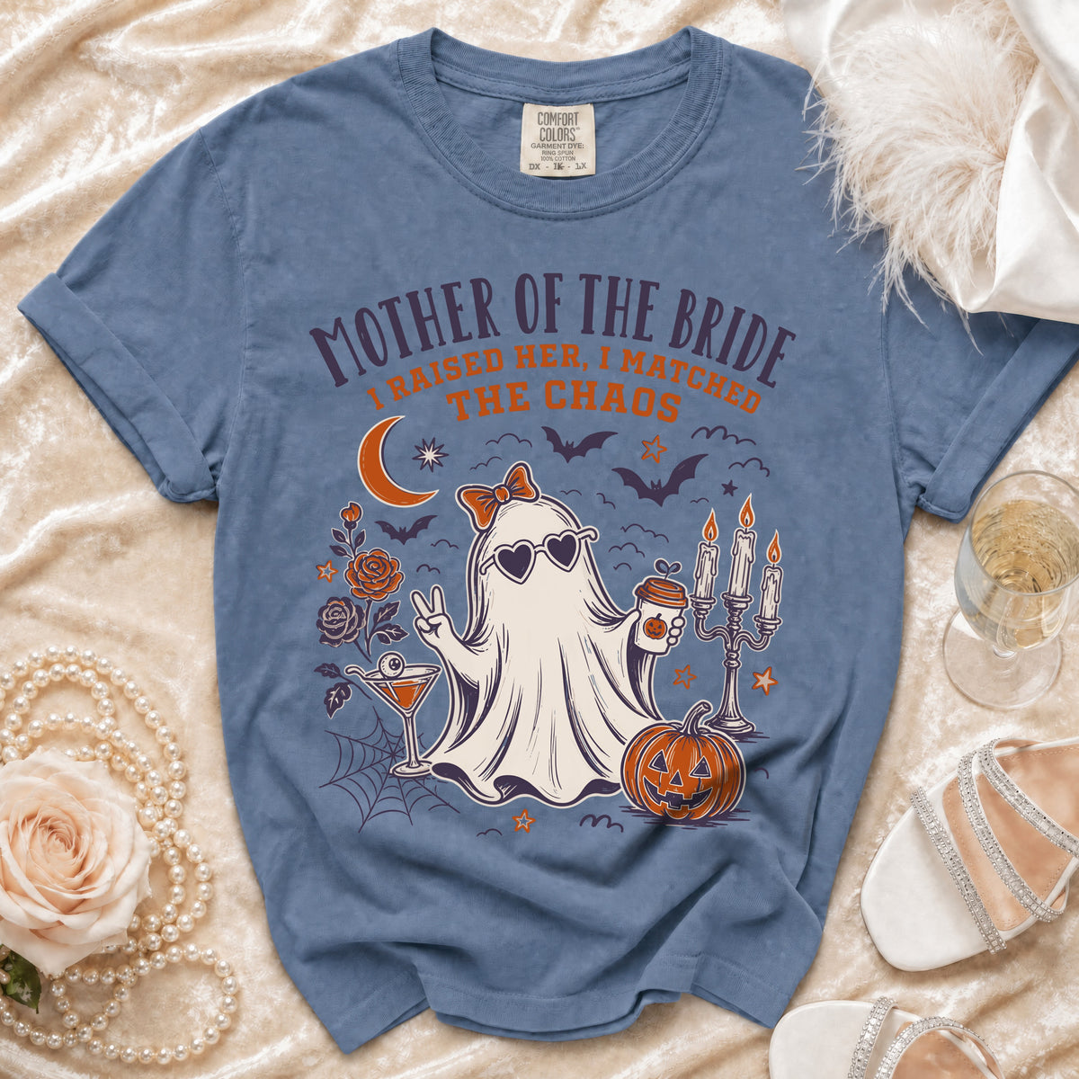 Blue Comfort Colors t-shirt with "Mother of the Bride I Raised Her, I Matched The Chaos" graphic.