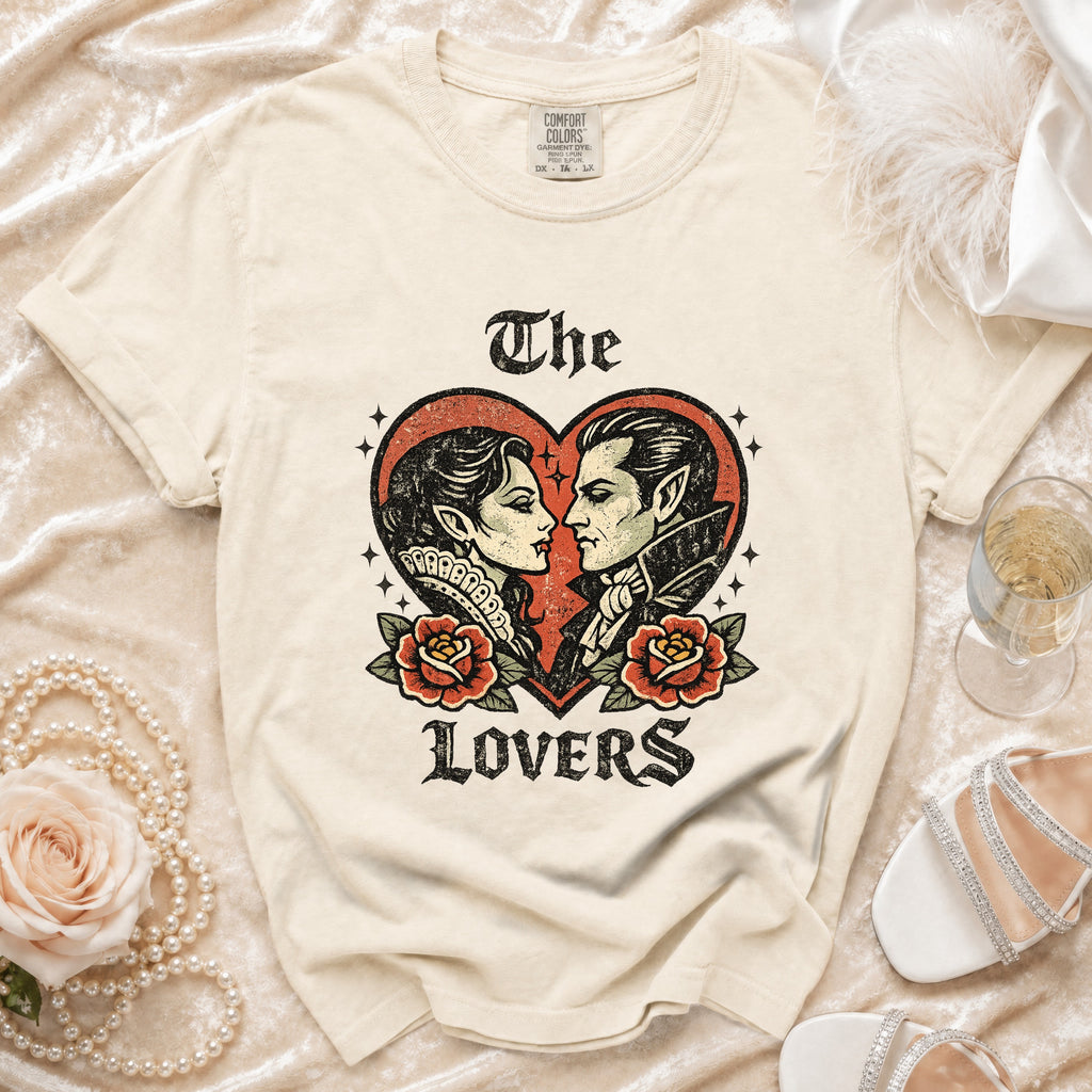 Cream t-shirt with "The Lovers" graphic of a vampire couple and roses.