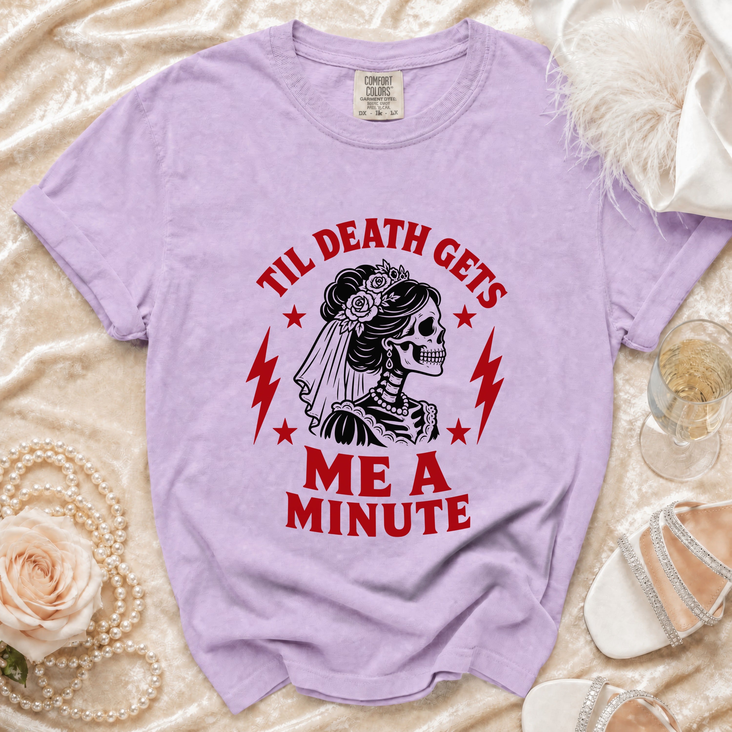 Purple t-shirt with skeleton bride graphic reading "Til Death Gets Me A Minute".
