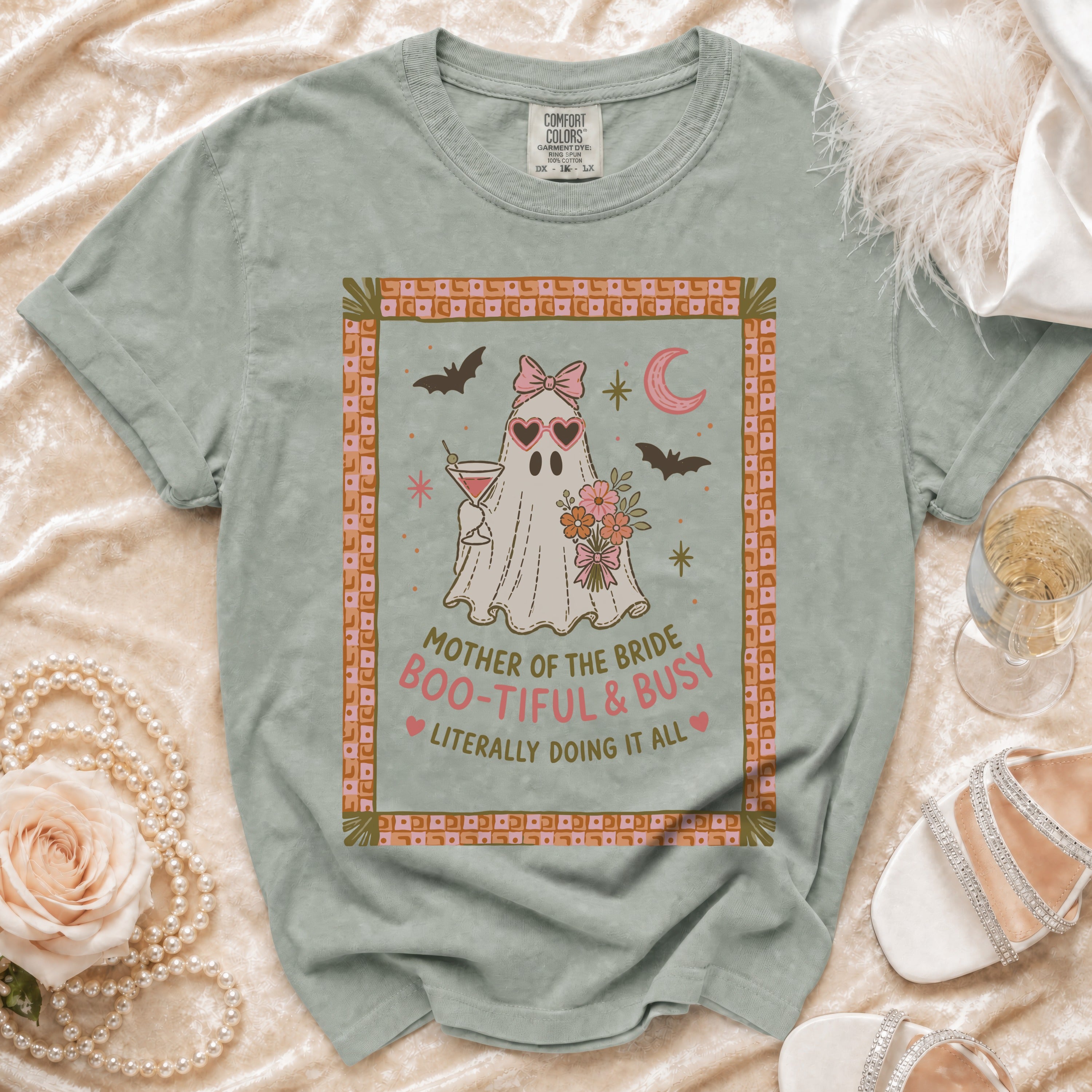 Ghost graphic with text "Mother of the Bride Boo-tiful & Busy" on a green t-shirt.