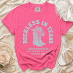 Pink t-shirt with "Reckless in Texas" and "Olivia's Bach Austin, TX Summer 2026" text.
