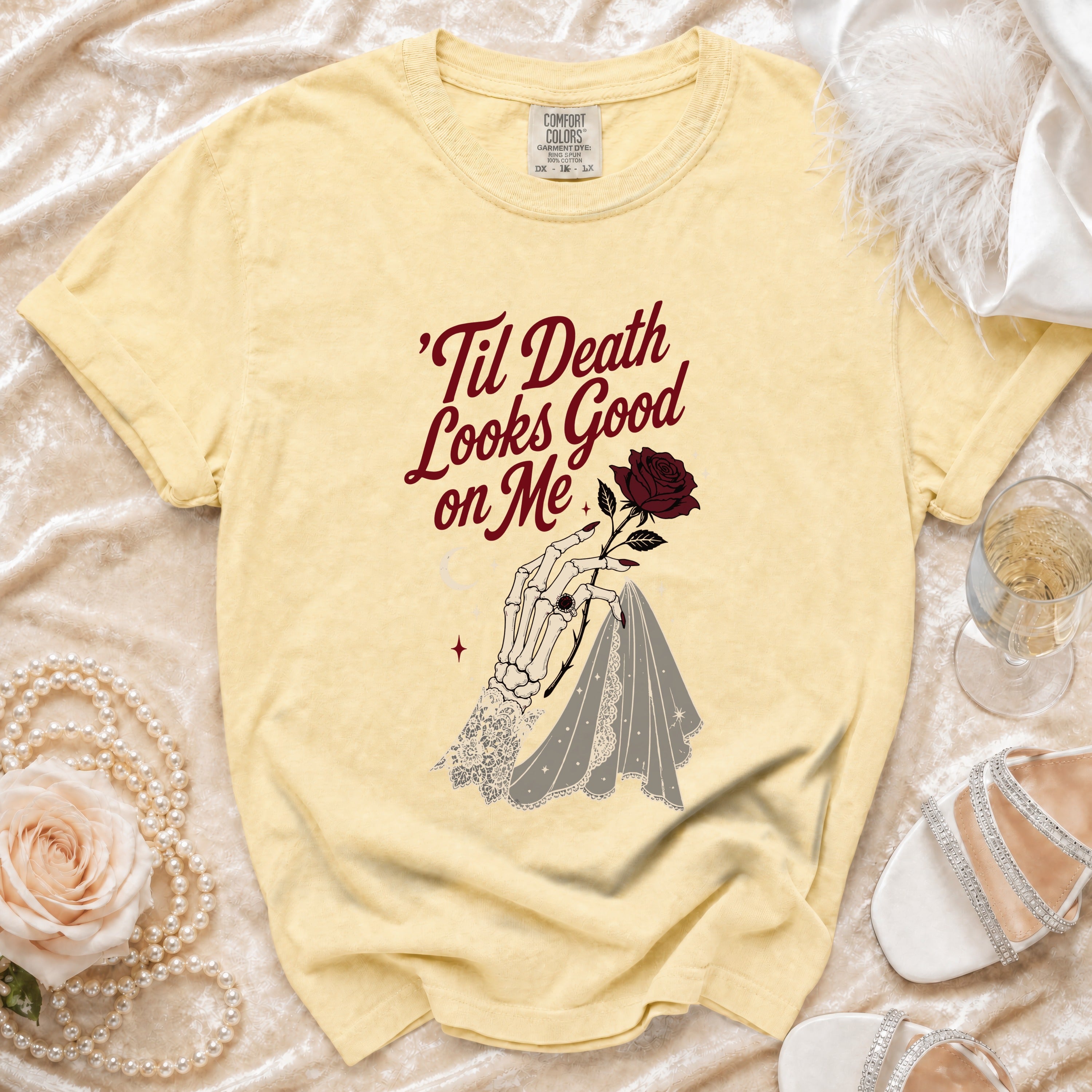 Yellow t-shirt with skeleton hand, rose, and text "'Til Death Looks Good on Me".